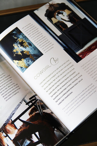 detail image of page of Extraordinary Interiors by Jane Rockett & Lucy St George on black and bronze table