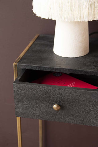 Close-up detail image of the Sophos Single Drawer Bedside Table with the drawer slightly ajar with pink velvet lamp on top and dark wall background