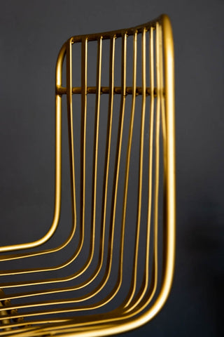 Close-up detail image of the back of the Midas Bar Stool with dark grey wall background