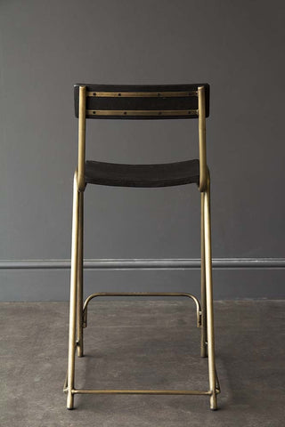 Black and gold simple and stylish barstool with gold legs and black seat and back panel. 