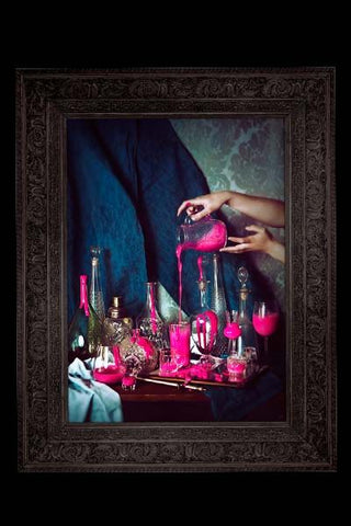 detail image of Still Life Canvas Print - Pink glass vases and bottles with pink paint being poured over them with black frame on black wall