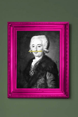 lifestyle image of the yellow pencil canvas with printed frame black and white portrait with yellow pencil in mouth and pink frame on green wall