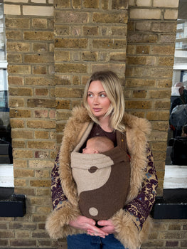Grace Chadd stood against a brick wall with her baby. 