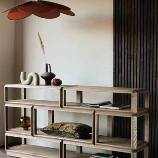 Image of the palm springs shelving unit styled with rust accessories, such as vases, cushions and candles
