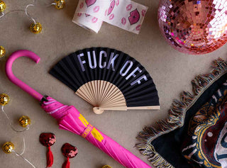 A photograph showing lots of festival essentials, including an umbrella, a fan, a glitterball and a throw