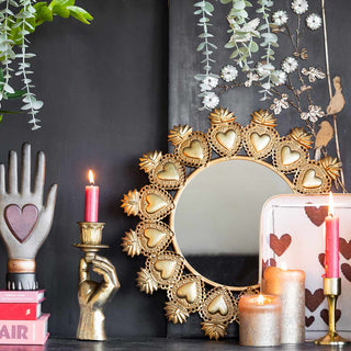 Heart mirror, lit candles and accessories