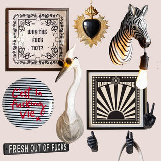 A montage of quirky wall decor, including a zebra head, sweary decorative plate and a hand-shaped wall hook 