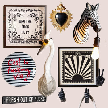 A montage of quirky wall decor, including a zebra head, sweary decorative plate and a hand-shaped wall hook 