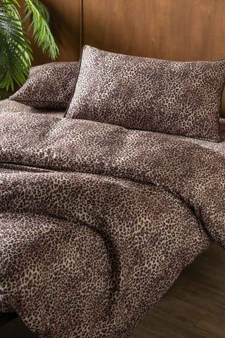 A leopard print bedding set styled on a bed