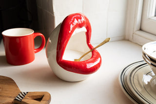 A salt pig designed as a pair of bold red lips