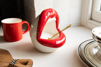 A salt pig designed as a pair of bold red lips