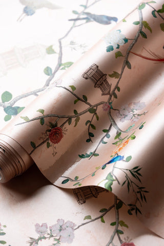 A roll of pink, floral wallpaper 
