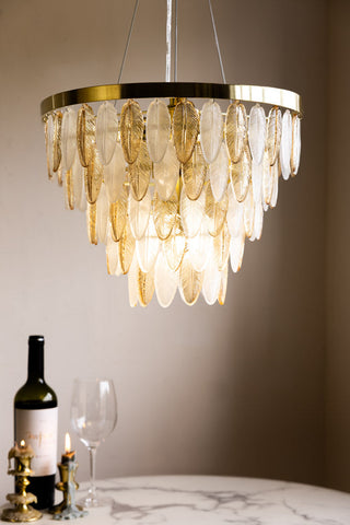 A gorgeous glass feathered art deco ceiling light hung up.