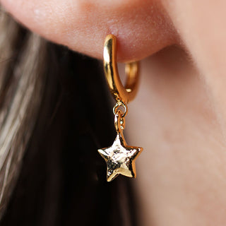 Gold star hoop earrings.