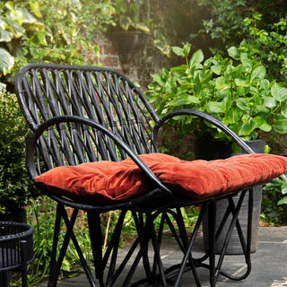 lifestyle image of black bamboo chair in the garden