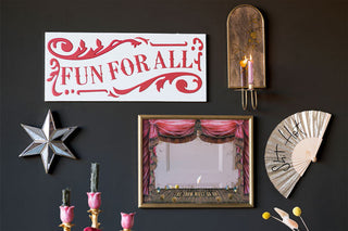 A gallery wall that features wall sign, decorative mirror, candle sconce and fan 
