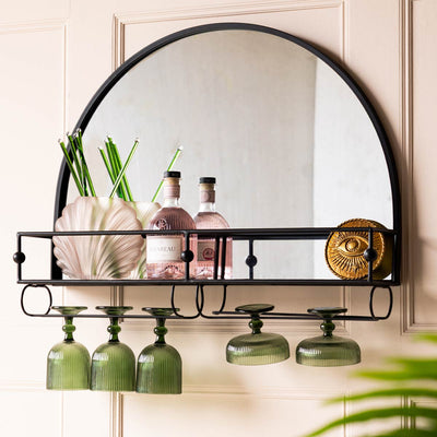 A black bar mirror with various accessories on.