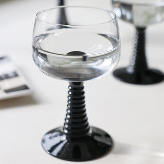 Multiple 70s French Style Wine Glasses In Black displayed on a table together.