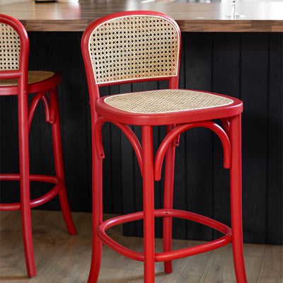 Two red bar stools next to a kitchen island.