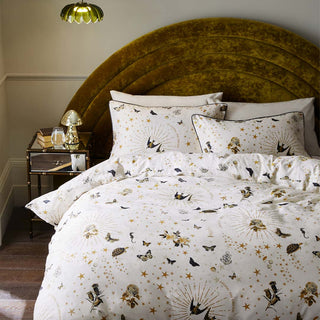 The Jane's Rose Duvet Cover and Pillow Case Set displayed on a bed in a bedroom, styled with various home accessories.