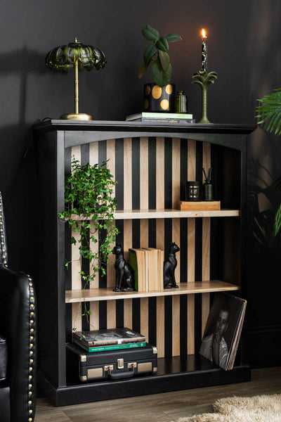 A stripe wooden shelf styled with various kitchen accessories and some plants.