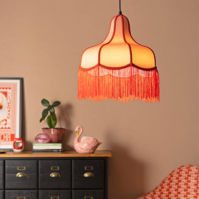 A gold cherub ceiling light styled above some accessories.