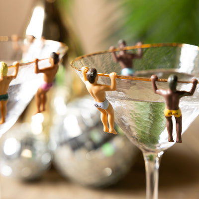Novelty drink charms displayed on some cocktail glasses.