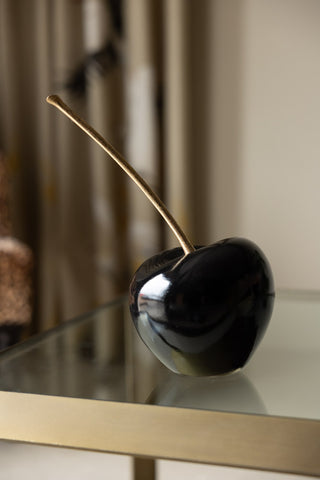 Small black cherry ornament on side table 