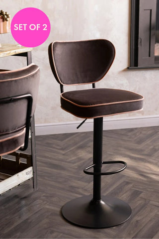 The Set Of 2 Adjustable Bar Stools in Chocolate Velvet styled next to a wooden island and set of 2 badge.