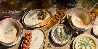 Decorative ceramic plates with various designs on a wooden table.