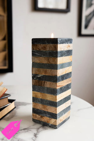 The Wood & Slate Tealight Holder with a lit tealight inside, styled on a white marble table.