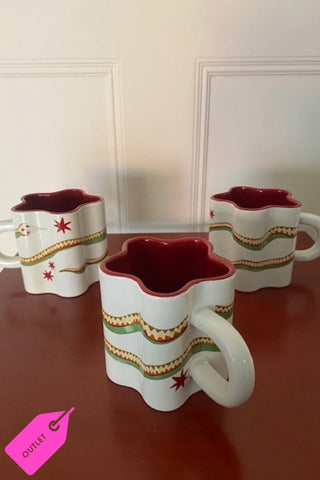 Set of three Star Shaped Mugs with Snake Print Detail on a red surface.