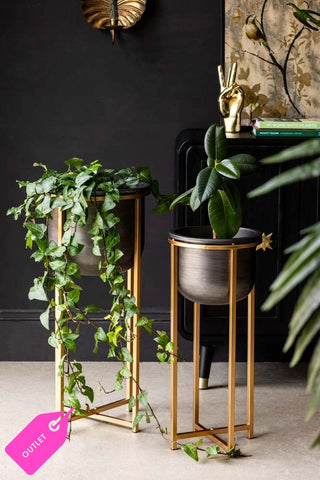 Lifestyle image of the Set of 2 Black Planters With Gold Stand