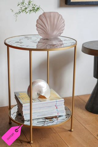 Lifestyle image of the Gold Beautiful Birds Mirror Side Table styled with decorative accessories. 