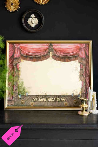 Framed theatre curtain print with 'The Show Must Go On' text on a black background