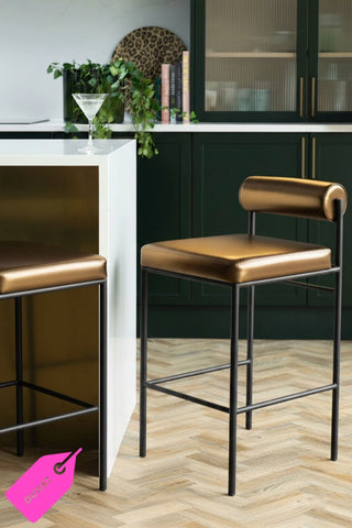Lifestyle image of the Burnished Gold Roll Back Bar Stool photographed in a kitchen setting.