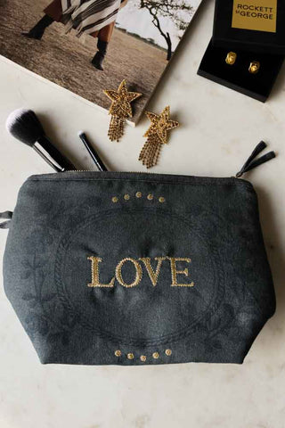 Lifestyle image of the Embroidered Love Cotton Pouch