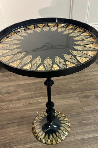 The Black & Gold Art Deco Inspired Side Table on a wooden floor