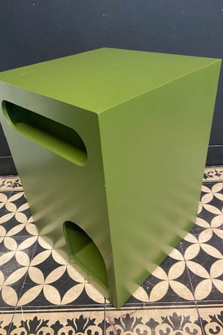 Image of The Green Alcove Wooden Side Table on a geometric floor against a dark wall