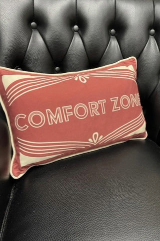 Close up of the The Heritage Comfort Zone Cushion In Red styled on  black leather chair