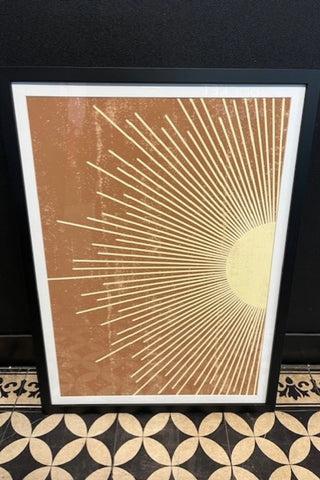 Image of the Graphic Sunburst Art Print - Framed - on a geometric surface