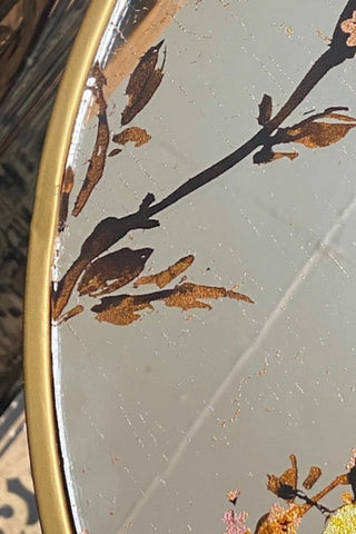 Close up image of the Gold Beautiful Birds Mirror Side Table showing the edge of the surface.