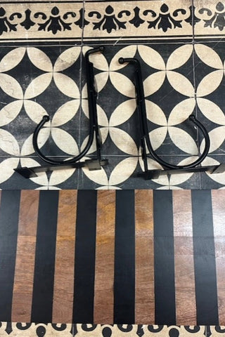 Close up of the Black Stripe Wooden Shelf With Bracket on a geometric floor