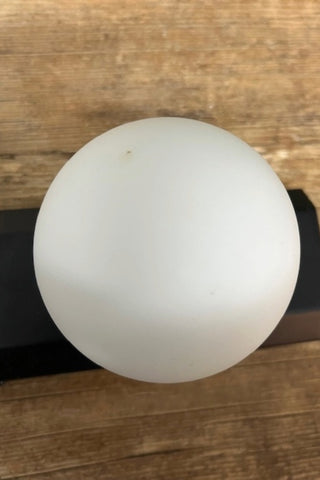 Detail of a globe on The Hollywood Vanity Wall Light in Black.