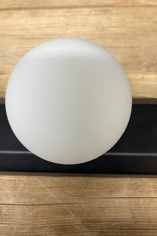 Detail of a globe on The Hollywood Vanity Wall Light in Black.