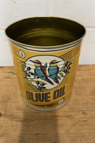 One of the Set Of 2 Olive Oil Storage Tins on a wooden surface.