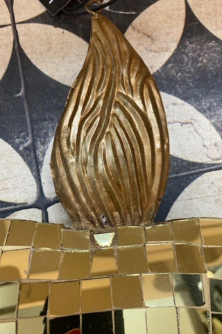 The top of The Disco Ball Flaming Heart Decoration on a patterned background.