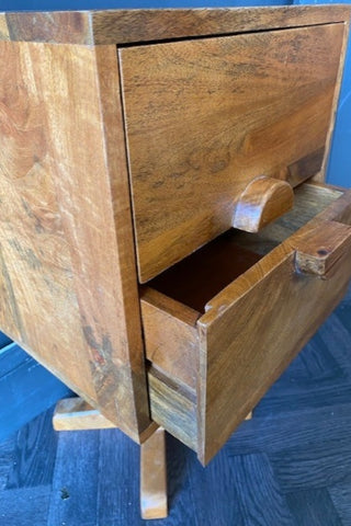 Side view of the Close up view of The Brown Wooden Footed Bedside Table with drawer slightly open.