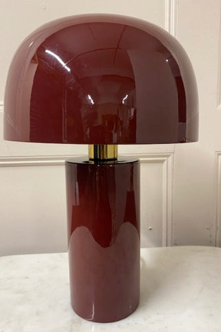 Close up of deep red, glossy table lamp