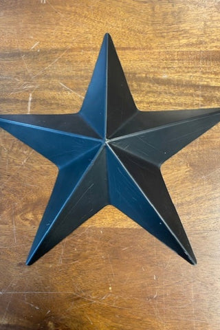 Image of the large star from the Set Of 3 Black Metal Stars on a wooden background